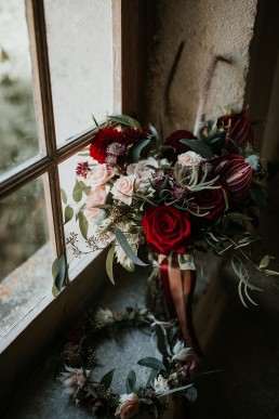 Bouquet de mariée posé sur le rebord d'une fenêtre confectionné par LILAS WOOD - Fleuriste Mariage Dijon & Bourgogne. Photographe : Coralie Lescieux